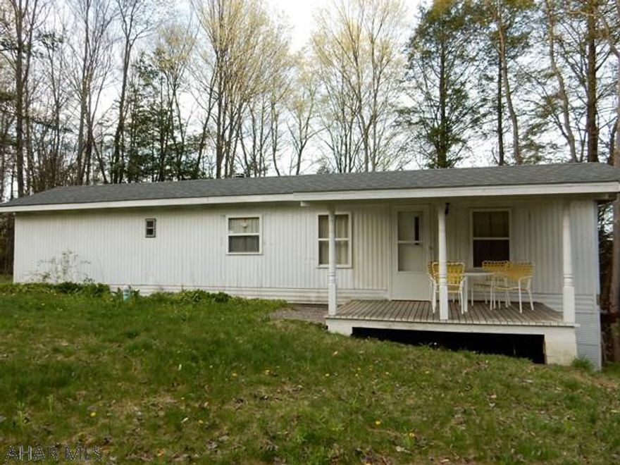 If you love life at the Lake, here is your chance to be close by! Close to lake, state game lands, quiet area/  Could be used as a home or a camp. Newer Pitched shingle roof, Large family room addition. Property has 2 other mobile homes that are thought unlivable.