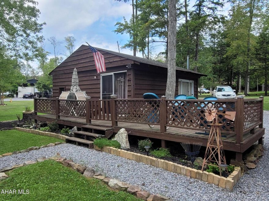 Are you looking for a place to relax with a view of the water, but are on a budget?  This camp has all that and more.  The camping unit has an addition that more than doubles the space a normal camper would have.  There is sleeping space for up to nine people.  The living room has some sleeping arrangements, sitting space and sliding doors that open onto a deck that overlooks the pond across the road.  A well appointed outdoor kitchen is located in one of the two sheds.  A covered area allows you to enjoy the outdoors in any weather.