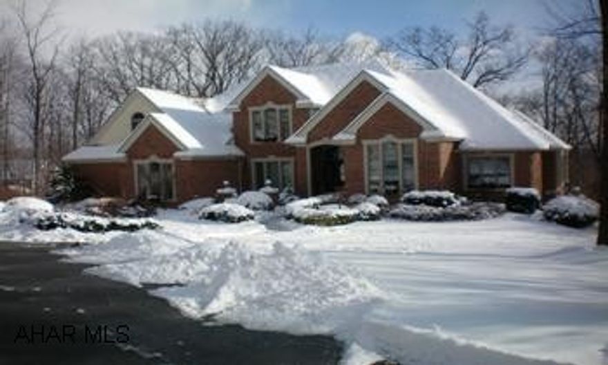 Elegant home in Sylvan East.  Gorgeous foyer with curved staircase, 1st floor Master.  5 BR/4.5 BA.  Finished walkout basement with bedroom / bath could be for inlaws.  Lot is private, wooded with a pond.  The best lot in Sylvan East!