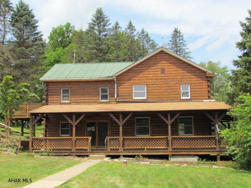 This rustic log sided home is on 1.9 acres of rolling pasture and woods. Wrap around porch and deck are perfect for enjoying the quiet outdoors and local wildlife. Stone accents and pine board flooring highlight the rustic interior. Belltown area Dormanstown Rd runs from Vira Rd to the Point Store.