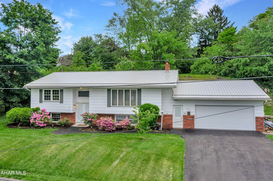 This beautifully updated 4-bedroom, 2-bath split-level home offers more than 2,700 square feet of inviting living space designed for modern comfort and functionality. The bright, white kitchen showcases stainless steel appliances and a timeless subway tile backsplash, seamlessly connecting to the dining area with easy access to the patio - perfect for summer cookouts and outdoor entertaining. Nestled on a spacious 0.45-acre lot, the private backyard offers a quiet escape. The finished lower level features a warm and welcoming fireplace, a built-in bar for hosting guests, and a separate exercise room. Updated bathrooms and new flooring throughout add a fresh, contemporary feel, while the large attached garage provides ample room for parking and storage.