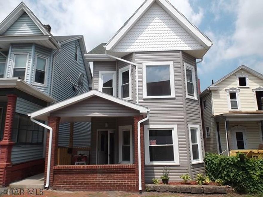 Completely remodeled interior.  New carpet and flooring, new windows, plumbing, electrical, lighting fixtures and fans, interior doors, kitchen with new appliances and new bath.  Exterior improvements include new poured cement front porch, vinyl siding, and side deck.  First floor laundry has stackable washer/dryer.  Attic is finished with new carpet, but unheated.  Kitchen has breakfast bar, eating area with recessed lighting, and door to new side deck.  There are 2 living rooms along with a formal dining room.  Offstreet parking pad in rear for 2 cars.  There's nothing left to do except move in!