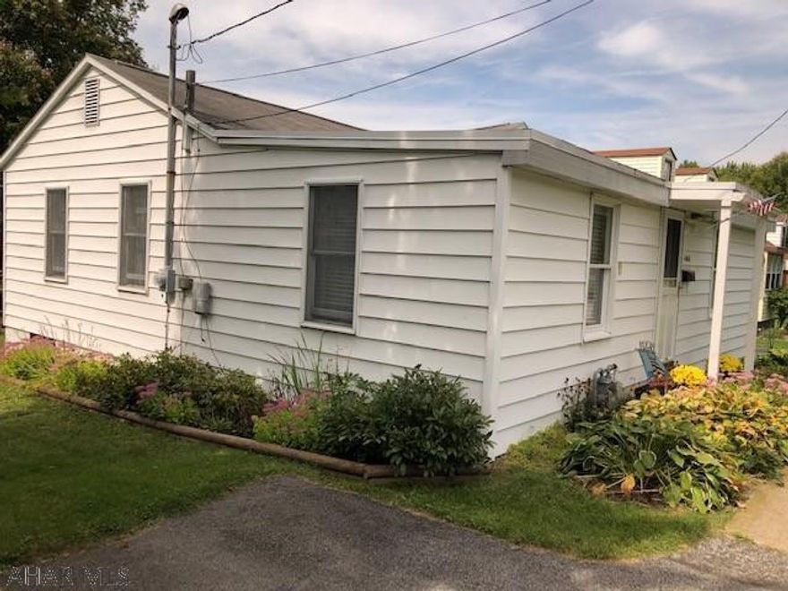 Immaculate three bedroom one story home on a nice lot. This home features a large dining room, hardwood flooring in the bedrooms and hallway, The wall between the living room and dining room was put  in by the seller for privacy, it could easily be removed to have an open concept. This home has a nice basement with a walk out to the large lot. No garage but room to build one. Absolutely beautiful  back yard with grape arbor and very private. This home is move in ready and kept up very well.