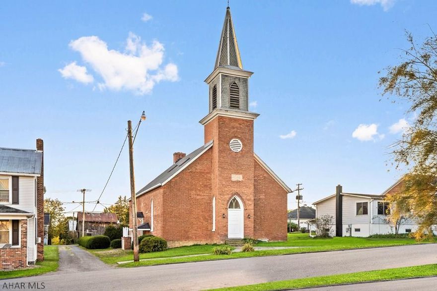 In the midst of historic Schellsburg, PA rests this spacious 1870's church transformed into a captivating home. Main level offers a foyer w/ massive 3-paneled cherry entry door, great room w/ 15' sandstone FP, custom kitchen w/ Subzero frig, Wolf range & large center island, dining room, owner's bedroom w/ c. tile en-suite bath, central bonus rm &  bath. 2nd level w/ loft overlook, bedroom & full bath. Finished bonus rm leading to the original bell tower. Full finished bsmt consisting of a bedroom/rec room, office & additional  bath. 3-brick thick walls, fully framed & insulated, makes this a quiet abode. Radiant HW floor heat, custom made cherry railings, arched windows & original exposed trusses. Detached garage w/ finished loft. Simply a fascinating home or could be a high end airbnb.