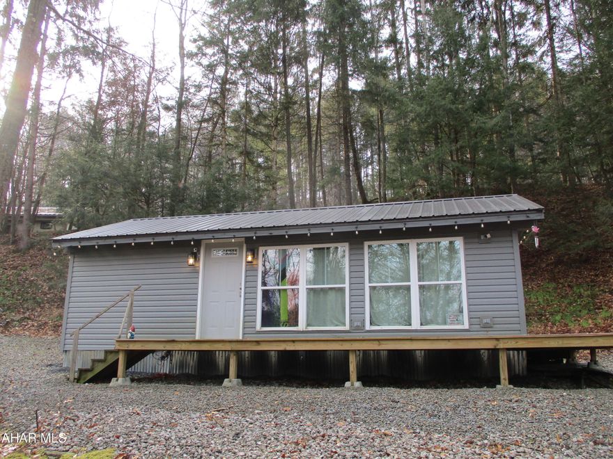 Here is your opportunity for a place to stay close to Glendale Lake! Nice camper turned into residence located in Glendale Yearound. Treated lumber deck, metal roof, vinyl siding, new windows, drywall and updates. Nice open living space with eat in kitchen. Nice tiled shower. Great opportunity for a vacation spot while living in the Yearound with all of the amenities including swimming pool, basketball court and more.  Camper does not have title with it. Being sold without title. Unknown year, make or model of the trailer. This is a camper that has been modified on a campsite lot.