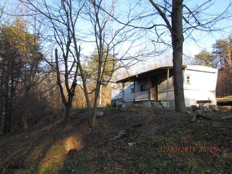 Wolfe Lane, Orbisonia, PA- Privacy is yours on this wooded 25 acres- mobile home is in poor condition, was heated by woodstove that has been removed