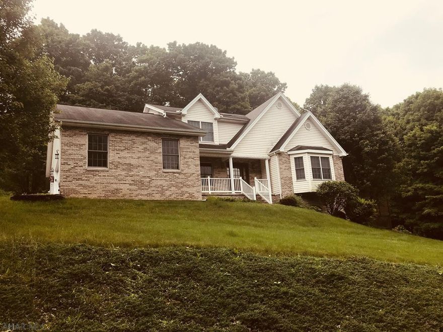 This custom buildt home has been beautifully renovated inside and out.  The recently updated kitchen includes granite counters on custom built 8 ft center island, bar area with second sink and built in desk.  A huge two story family room is flanked by a wall of windows while the sunroom leads to a new gorgeous private pool.  First floor master suite includes huge walk in closet and private bathroom retreat.  The lower walk out basement adds another family room and large workshop.  Hardwood floors, ceramic tiles, cathedral ceilings, new landscaping and a fabulous in town location add to the outstanding appeal of this stunning home.