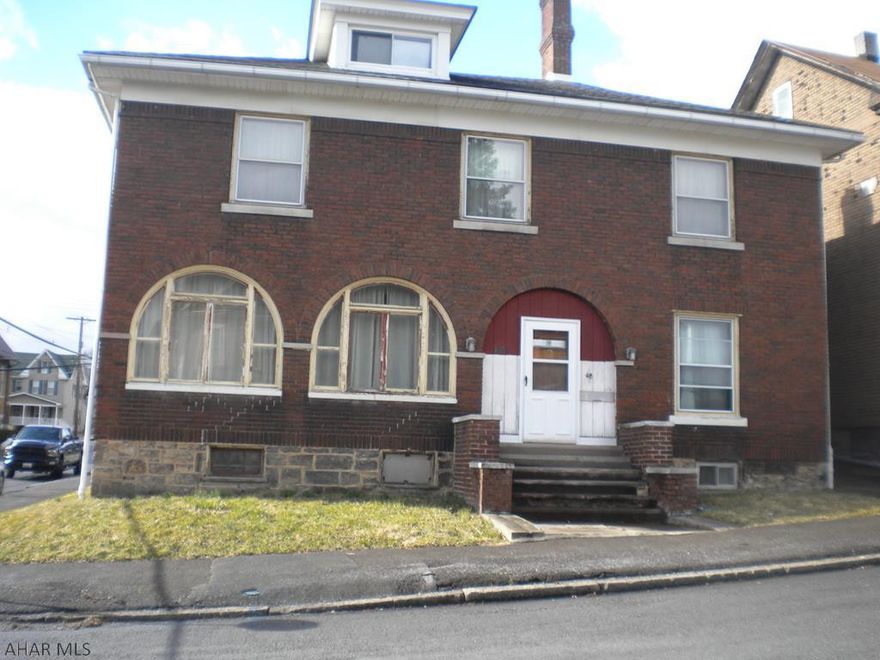 If you are looking for a large family home...this is it!  5 bedrooms upstairs and 1 possible on the first floor. This home has all the original woodwork, hardwood floors  and character is was built with but needs a little TLC. The owner had the original kitchen cabinets replicated to add additional ones so they would match and added corian countertops & vitrolite backsplash. There is also a 2 car garage for your cars. The basement is dry with plenty of storage and a work room complete with a huge workbench. This home has so much potential. It was custom built by Dr. Meminger in 1928, sold to Bishop Guilfoyle in the 70's and used as a convent, then purchased by the most current owner. Mechanics have been upgraded. Fireplace never used by current owner.