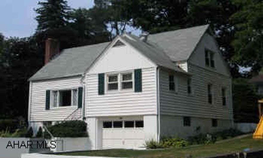 Cape Cod located close to schools and shops. Fireplace in Living Room, thermal glass windows; modern kitchen; hardwood floors, ceramic tile in kitchen, patio in back.