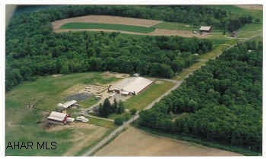 Extraordinary  horse farm with many added features.  Heated indoor riding arena with washroom, 60 stalls, automatic waterers in each stall, lounge with .5 bath.   Bank barn with 10 stalls on lower level.  milkhouse, 2 runout sheds, hotwalker, blacksmith shop, 28 x 70 pole garage, outdoor riding arena, and many other features.  Call agent for details.