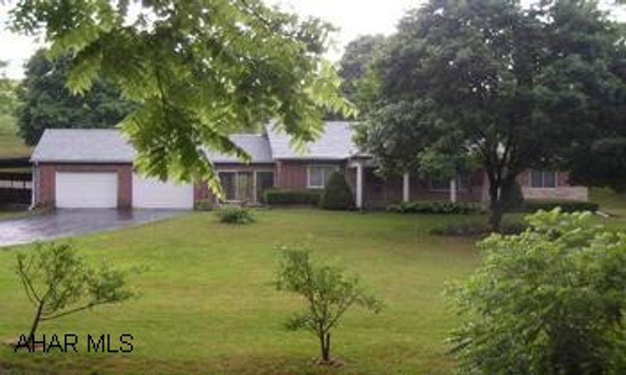 Part of D7123 One owner brick bungalow with serene setting!  Hardwood floors, plaster walls, enclosed breezeway, 2 car attached garage, 1 carport, walk-out and partially finished basement.