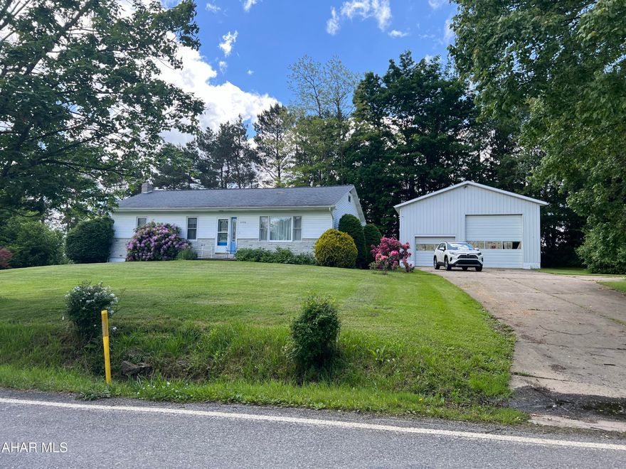 Country setting -  vinyl sided rancher on slightly over an acre lot. This home features 2 bedrooms, one bathroom, living room, dining room, kitchen and den. The den could possibly be used as a third bedroom. Full unfinished basement.  Nice yard with trees and shrubs. Large detached garage (30x40) with 14' ceiling (right side housed a motor home) and  a concrete drive.
