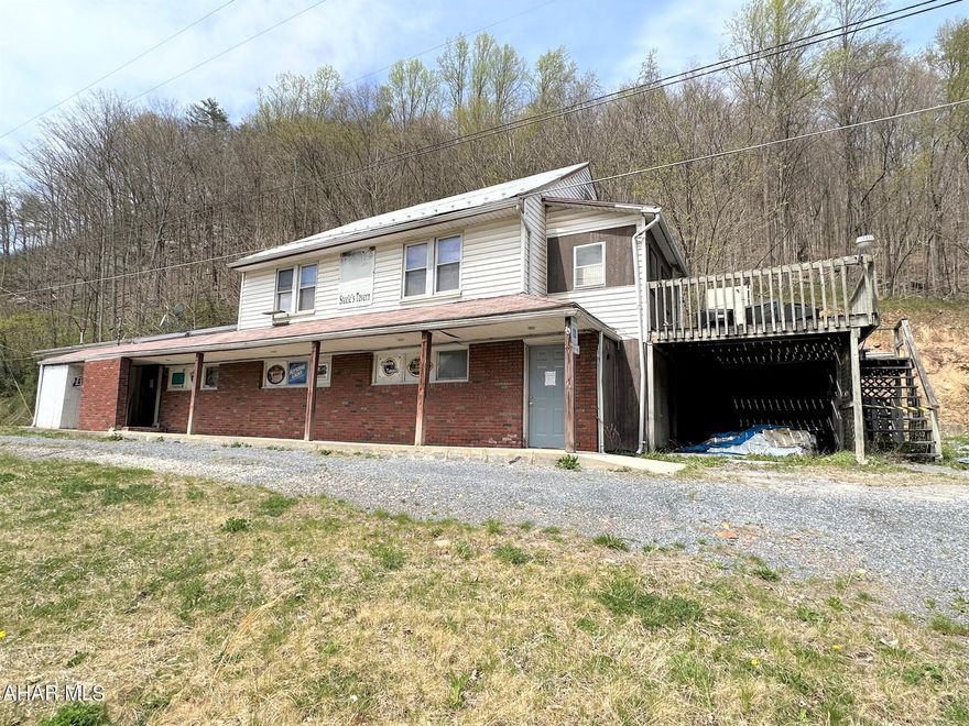 This former tavern/restaurant is ready for a new owner!! Sale includes liquor license, furniture, fixtures and equipment. The main floor of the property offers bar area, stage, large lounge, gaming areas, kitchen, cooler/storage rooms, and restrooms. The second level has an apartment with one bedroom, kitchen, living room, office, one bath and laundry room. Large parking lot to accommodate customers. This is a great opportunity to own your own business!! Property is being sold as-is and where is.