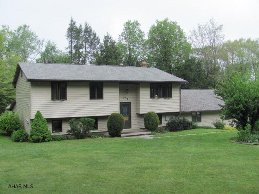 Cambria Heights SD- 3-4 BR vinyl Bi-level on approx 1 acre.  Wet bar in basement. Coal, oil & wood heat. 3 car attached garage & 1 car detached garage.  Great location.