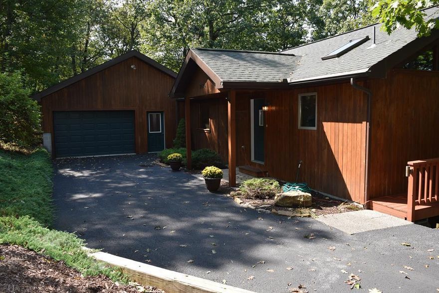 This amazing cabin is located in Shy Beaver Estates, a fantastic Raystown Lake neighborhood, 5 minutes from Shy Beaver Boat Launch. Bring your boat and your family to this home nestled in the trees. In the summer it has a feeling of being its very own treehouse, but come Fall and Winter the views of the lake and Allegheny Mountain Range are impeccable, you may even get a glimpse of our local Eagles soaring about. Inside find a well maintained home with that highly desired open concept, cathedral tongue and grove ceilings, and floor to ceiling stone fireplace. This cabin comes with a new Lennox furnace and heat pump, first floor master suite, two spacious bedrooms, tons of closets and storage space, two living areas for lots of entertaining, and a very large garage. Priced to sell quick!