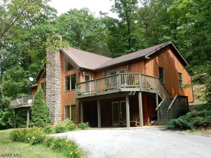 This 1 story A frame is just spectacular.  Main floor is an open concept with vaulted ceilings, recessed lighting, wood burning fireplace, beautiful views and only a 10 minute walk to the lake at Shy Beaver Boat launch   3 bedrooms on the main floor, including a large master with private deck access and a 5 x 6 walk in closet. Laundry is conveniently located on the main floor, as well.  Granite countertops, porcelain floors, and island seating, set off the beauty of the kitchen.  The basement is very large and could offer 4th and 5th additional bedrooms, with closets.  A spiral staircase leads to a sitting area below,  which flows into another versatile 41 x 18 family recreation area.  A large storage area is located off the basement.. Private road and room to build a garage.