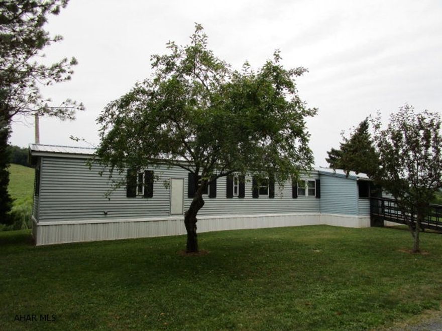 Well maintained single-wide home resting on 2.027 acres. This home offers 3-bedrooms, 1.5 baths, large living room, eat-in kitchen and laundry area. Updated metal roof, aluminum siding and replacement windows. Oil FA heat, front porch, rear deck with great views and storage buildings.