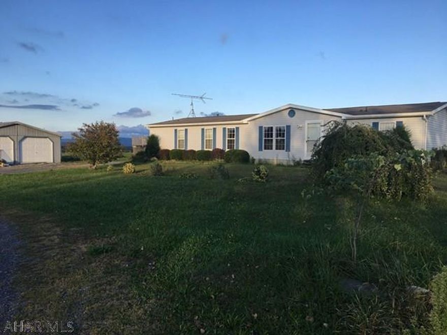 Double wide on full foundation on 2.5+ acres with spectacular country views. 2 car detached garage in need of roof repair. Above ground swimming pool with new liner and new pump. House and garage needs TLC. Electricity is off. Condition of utilities is unknown. Being sold AS-IS. Short sale with bank giving final approval.