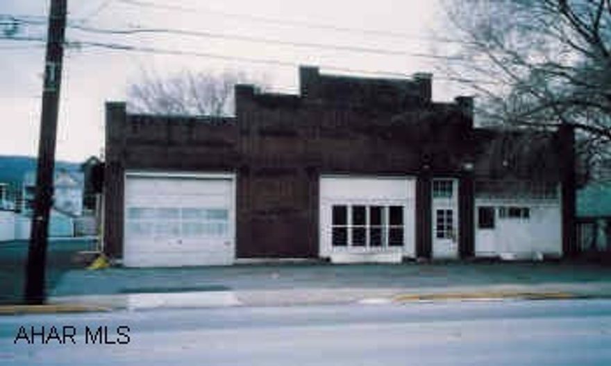 Block building with brick front. Could be used as garage, warehouse or retail space.