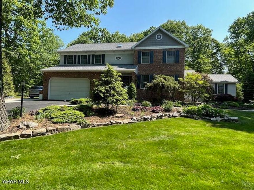 This home is absolutely exquisite! It boasts beautifully manicured grounds with a serene wooded setting. The first floor includes a renovated kitchen with gorgeous granite counter tops and a coffee bar, a spacious family room with a wood burning fireplace, a large office with lovely built-in bookshelves and cabinetry, an additional living room and a powder room.  The second floor includes a sizable master suite with a luxurious bathroom featuring a soaking tub, and large walk-in closet. This floor also has three additional bedrooms with ample closet space, as well as 2 additional full bathrooms and a laundry room. The finished basement includes a gas fireplace, a utility room, lots of extra storage space and a full bathroom. The 2 car garage provides ample space for vehicles and much more. The magnificent outdoor living spaces and wooded views include a beautiful covered front porch, a large deck with a Sunsetter awning, a lovely brick patio with a pergola, and a storage shed for lawn care and seasonal equipment. This home also includes a security system and central vacuum system.  *Some photos were provided by Seller and are in different seasons.