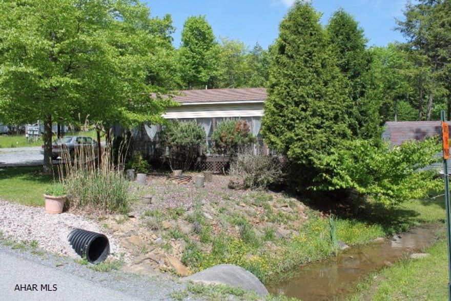 Well maintained 40 ft camper on a corner lot under a 9x38 ft covered pavilion with screened in porch..This camper comes with a full size refrigerator,goose neck faucet.