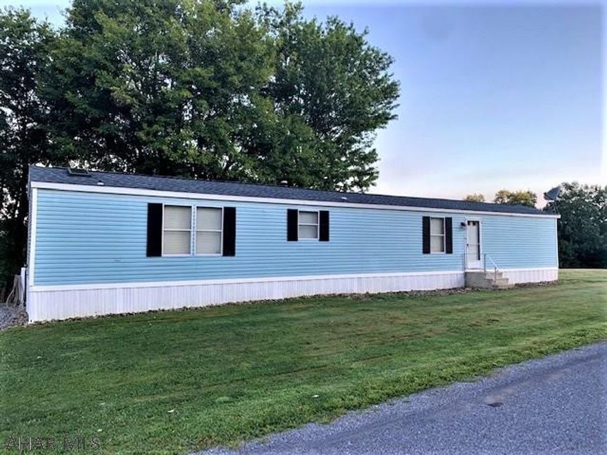 Looking in the Chestnut Ridge area for HOME SWEET HOME? Look no further!  Mobile home on a large lot with beautiful views!  Home has been well maintained with many updates.  2 Bedroom, 2 baths with skylights.  Enjoy your spacious living room and eat in kitchen.  Outdoor living with a big back yard and fire pit.  A carport  with electric and lights to park in come colder months and a garage for all your outdoor toys.  Sit back and take in the beautiful views on your back deck.  Close to I-99 and 20 minutes to Bedford. 11 minutes from Blue Knob State Park! Skiing is just around the corner!  Motivated seller!!