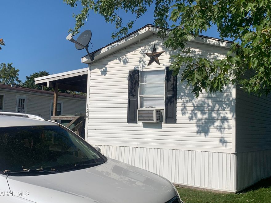 Are you looking to downsize or just starting out? This 3 bedroom, 1.75 bath 14x66 Fleetwood manufactured home offers updated bathrooms, updated kitchen (seller currently working on it), new lighting throughout & fresh paint (to be completed soon).  Enjoy the crisp Fall evenings on the large 9 x 28 front porch.  Off street parking.  Large shed with electric (could use some TLC).  Buyer to confirm taxes and square footage. Lot rent includes trash.  Buyer must be approved by park or trailer can be moved.