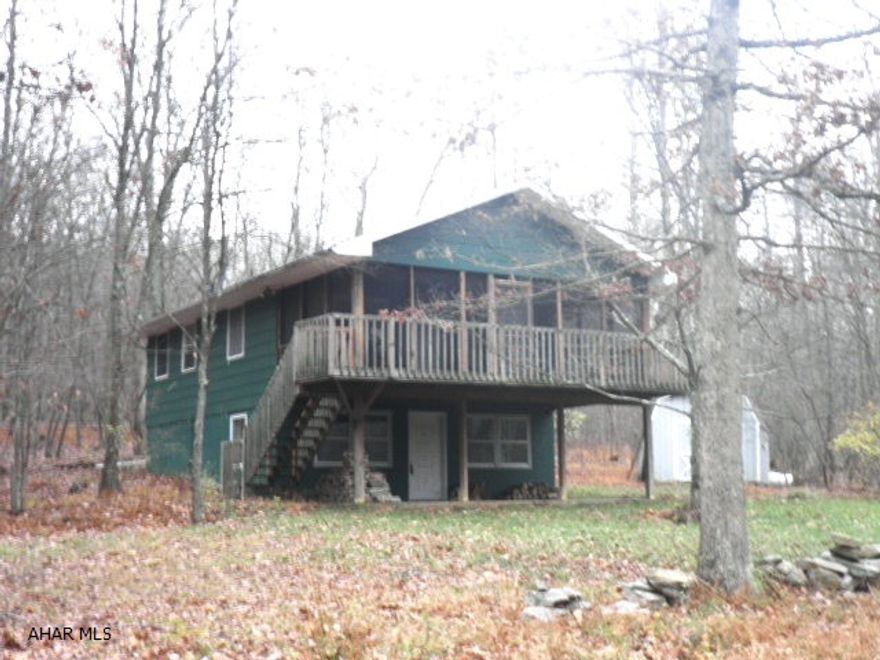 Ideal retreat for summer getaway, HUNTERS! Near James Buchanan St.Forest & pike to trails. Access @ top of lane once you come thru T-pike underpass from US 30, bear right on Oregon Rd., the access to pike to trails & Buchanan Forest. Private setting by Valley Hi Lake. HP w/elect.back-up & CA - new 2012. THIS IS NOT A HOMEOWNER ASSOCIATION.  Buyer pays membership fee (presently $675+-/year), a water coop.fee(currently $120+-/yr.& run by members)& must purchase water bond (presently $100.00+-).  Some lower level trim & BR ceiling need finish. SF of above & below grade levels are approximate. HOME WARRANTY AVAILABLE! 100% MONEY-BACK GUARANTEE (w/ stipulations)! PRIVACY & RELAXATION ON THE LOVELY SCREEN.-IN, FT. PORCH & PATIO. SEPTIC MAY BE HOLDING TANK. WATER TURNED OFF - DO NOT USE TOILETS!
