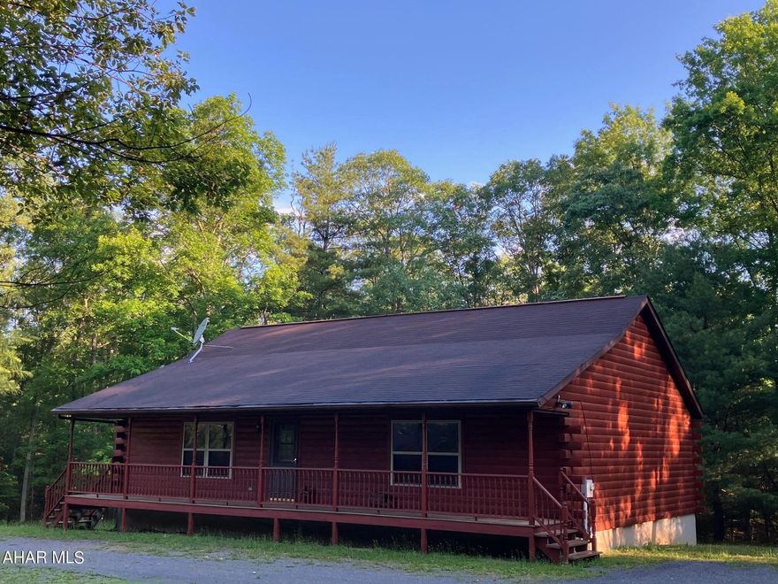 Sequester yourself within this serene sylvan setting!  This adorable home, nestled in a pleasant wooded area on 28 acres, and a little over 20 minutes to State College, is an ideal place to get away from the crowd. Enjoy one floor living in this darling log house featuring an open kitchen, living, and dining area with vaulted ceiling, propane fireplace, wood floors, and sliding door to a deck. The partially finished basement provides space for additional living and recreation, and expandability into the unfinished area as well for many flexible uses. An additional, well maintained, four stall horse barn and peaceful fenced pasture provides outdoor activity, storage and lifestyle options. The land is actually three lots from the original subdivision, united under one tax parcel, creating a potential to split one or two lots out in the future. Two wonderful parks in proximity (Stone Valley and Whipple Dam) offer hiking, fishing, swimming and other seasonal pastimes. Pass the end of the day away on your covered front porch and enjoy peaceful living today!