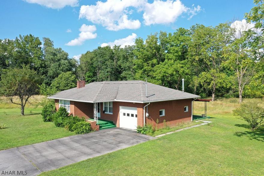 This is an updated brick ranch home in Hollidaysburg on 1.47 acres!  The home has hardwood floors throughout that have just been refinished.  The kitchen has a large island, new countertops, new cabinets, backsplash, and stainless steel appliances.  There is a formal dining room and expansive living room with brick fireplace with insert!  3 bedrooms and 1 full bath all on one level.  The windows are newer and the home has a new hot water tank.  There is even a 1 car garage!!  Riding lawn mower is included with a full price offer.