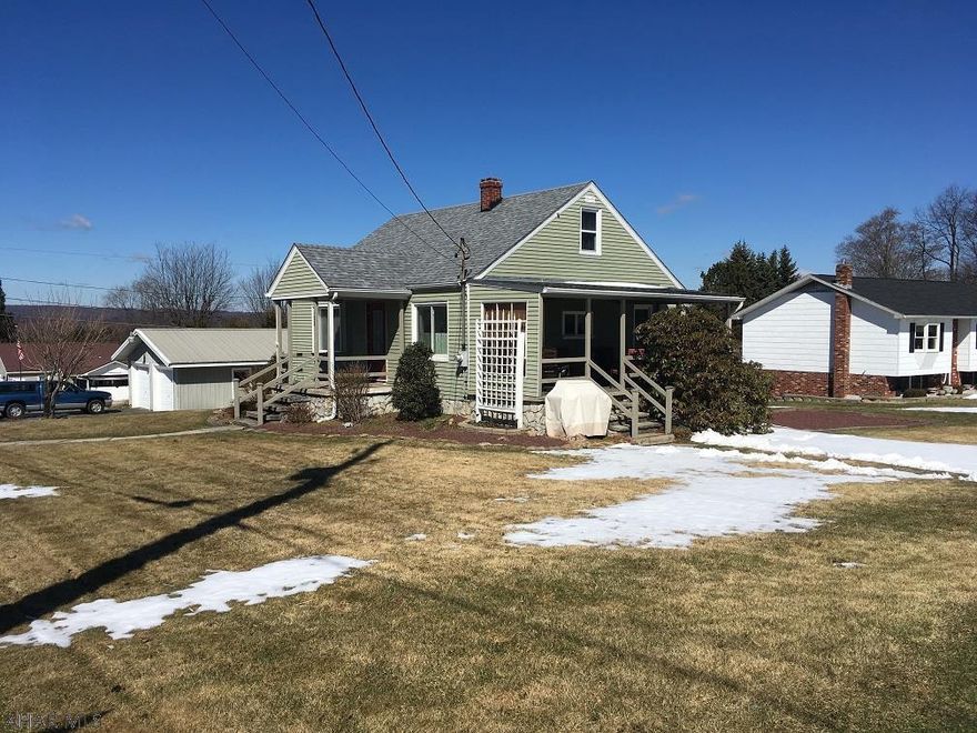 4 BR Cape cod on large lot with newer 2 car detached garage. Wall a/c in living room.