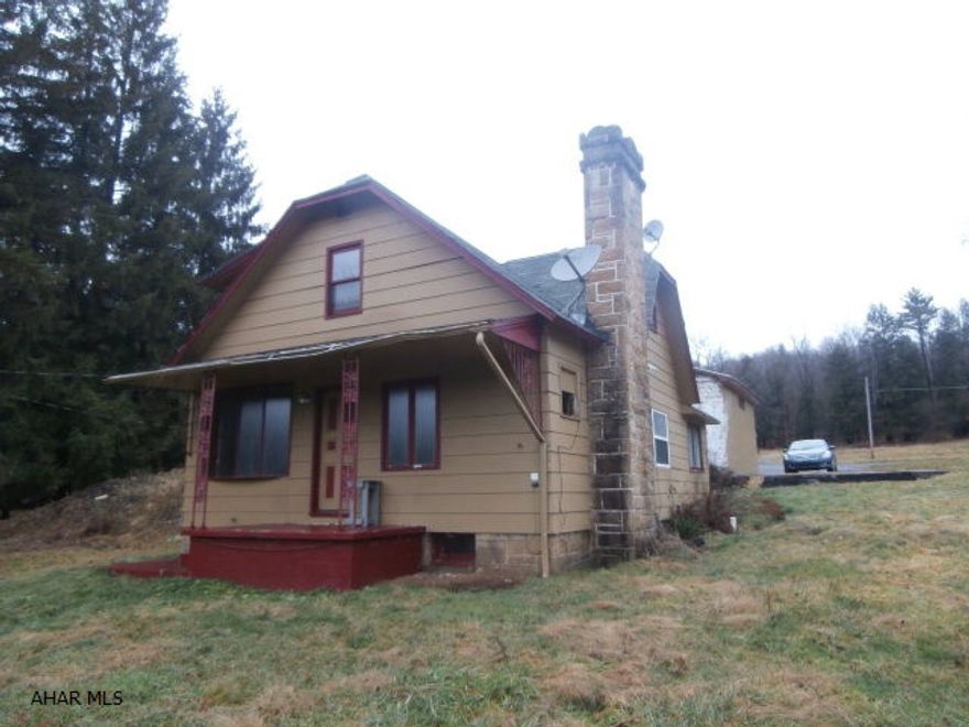 Property consists of a two bedroom 1.5 story house,(needs work), a mobile home pad currently rented for $230/mo, a detached 2 car garage with loft, pole garage and storage shed. Open septic tank next to house. House needs furnace. Being sold strictly in AS IS condition.