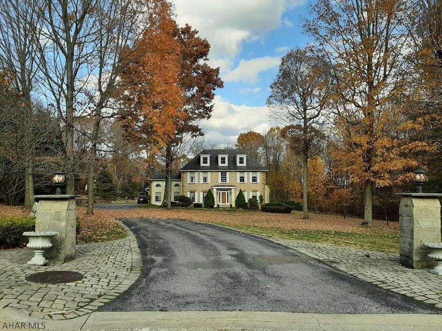 New Price!  TWELVE (12) acres in Westmont Hilltop School District to call your own!  Imagine that!  You get the best of both worlds with this stately, stone, Colonial home.  The house and in-ground pool are located in Westmont Borough.  The tennis court and 10 wooded acres are located behind the house in Lower Yoder Township.  If your family enjoys campfires, hiking, hunting or popping up a tent in the woods, you won't have to go far.  I've walked the property twice, and both times I left in a better mood.  I found the walks to be very calming and peaceful.  The air is so fresh.  The property is not grand or pretentious.  It is comfortable, beautiful, sophisticated, and laid back all at the same time.