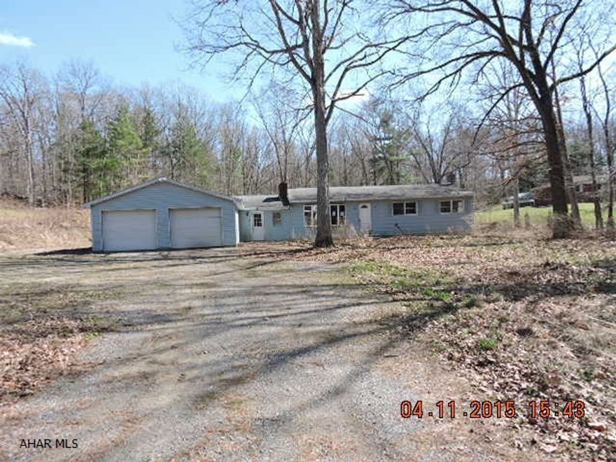Tons of potential with this property.  House needs a lot of work and is an AS IS SALE.  There is a 4400 sq ft metal building (a former indoor archery range) attached to the back of the house.  Basement has a 2nd fireplace. Well equipment and some plumbing missing.  Oil tank is not hooked up to furnace.  Well & Septic are unknown.  No utilities are on, take flashlight and use caution.