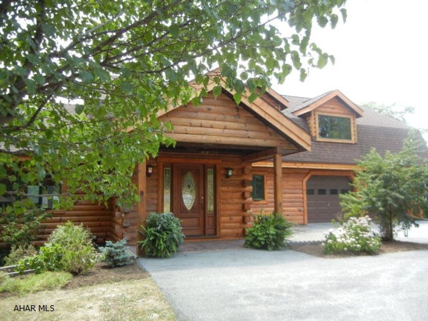 Gorgeous log home on approx. 33.3 acres. New kitchen with granite countertops, center island & copper farm sink. 1st floor & 2nd floor master suites. Beautiful stone fireplace-floor to ceiling open vaulted design. Heat pump plus propane backup. 2 car attached garage plus 3 car detached garage. Heated inground pool (fenced). Finished lower level includes wet bar, family room & 1/2 bath. Perfect home for large or extended family. Home protection plan included. Possible delayed possession.