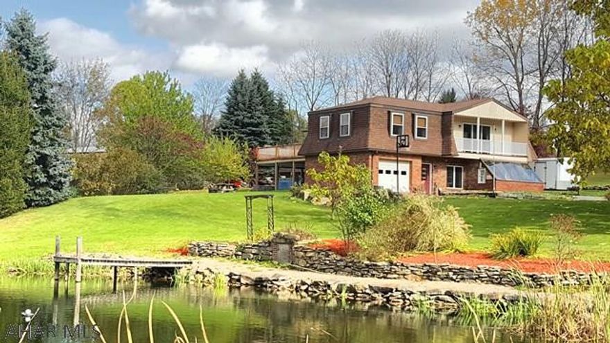 This beautiful unique home sits on 2.4 acre lot that has a pond and 5 bay detached garage!! The home features reclaimed old wood beams, trim and stain glass accent windows. Main floor is ground level with foyer, living/kitchen combo, dining room, 3/4 bath, laundry room, utility room and heated sun room. Second floor includes a large family room.with balcony, Master bedroom with en suite and walk in closet, 3 additional bedrooms and another full bath. Large deck off 2nd floor enclosed porch. Stamped concrete patio with hot tub. Shed.