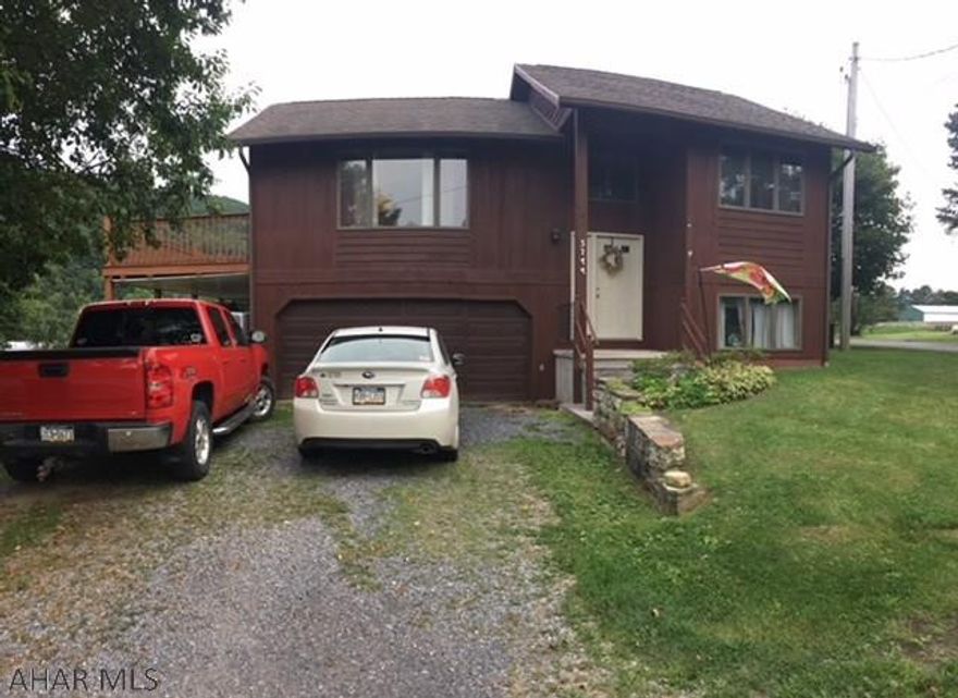 Completely updated cedar split level. New countertops, backsplash and flooring in open kitchen. Breakfast bar and dining room lead out to huge wraparound deck. Completely fenced in yard with shed. Open living room with big windows, a very welcoming space! Master BR has custom sliding barn doors on closet. Walkout basement has recreation room with laundry facilities and sink. Also downstairs is a bonus room which could be a third bedroom. Room for all the toys with a two car garage and carport under deck.