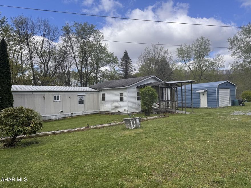 Sit in your backyard, relax and listen to the water from the Blacklick stream on your 2+ acre lot.  3 Bedroom mobile home with family room addition w/propane fireplace.    Appliances included.