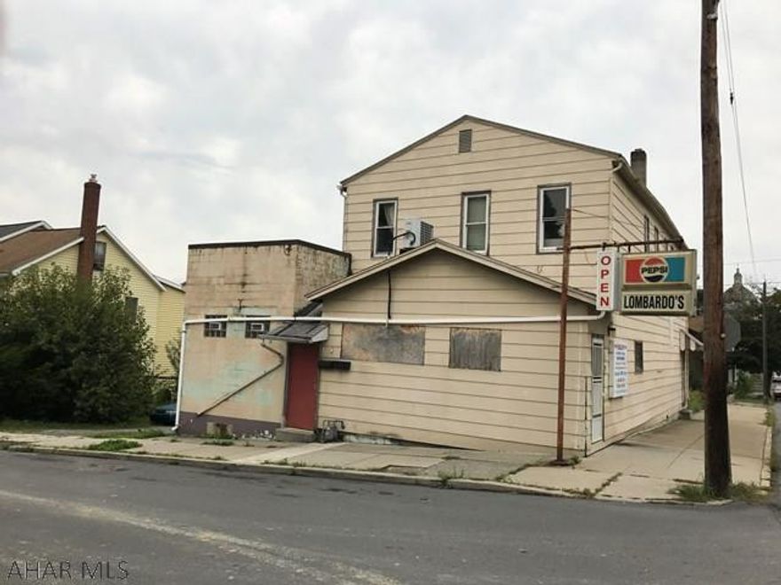Former Lombardo's Bar. There is NO liquor license. Needs work. There are two apartments on the second floor. The bar area would make nice apartments.
