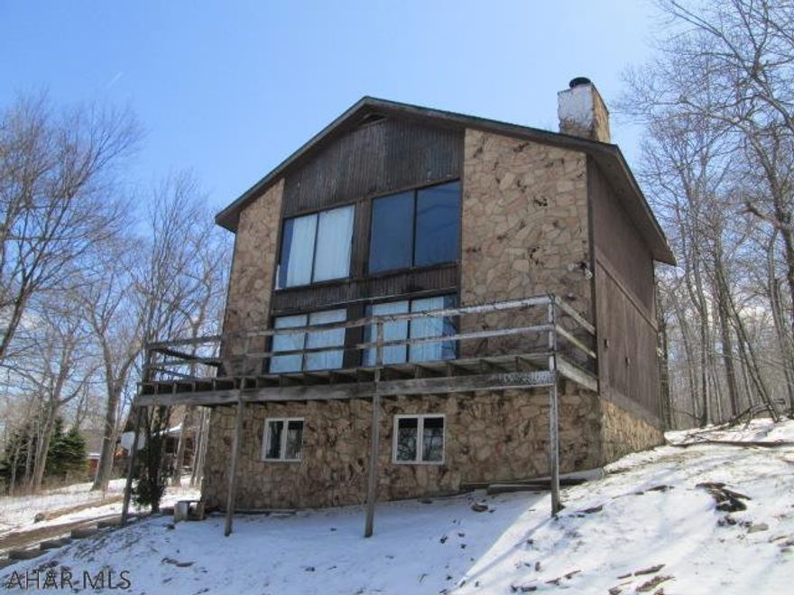 Blue Knob. Rare opportunity at mid station, ski in and ski out. This 4 BR, 2 BA will be sold fully furnished. To supplement the electric heat the home features wood stove and wood fireplace. Sit on spacious wood deck and watch the slopes!