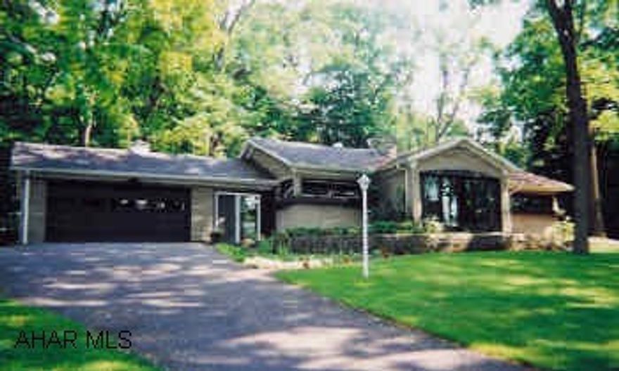 Stone faced rancher on 2-plus acres in wooded setting. Quiet neighborhood. Close to schools and shopping. In Meadowbrood Terrace.