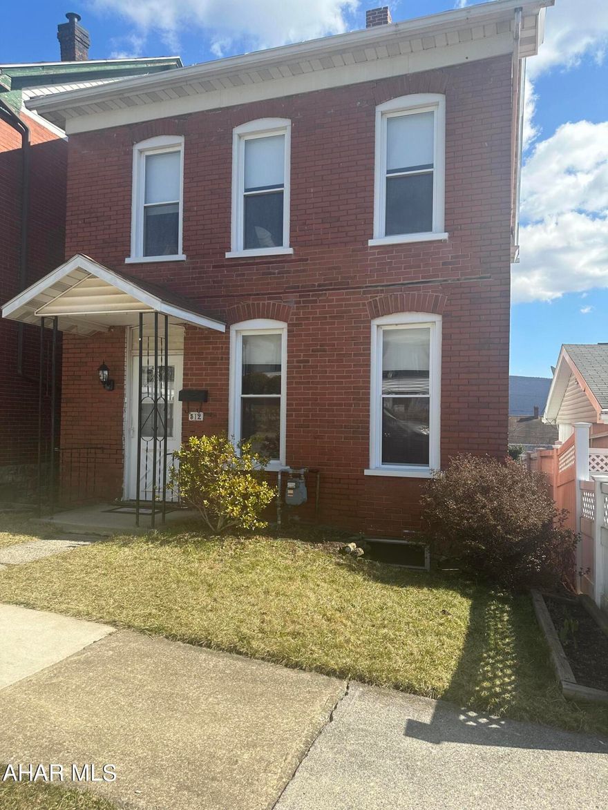Cute and cozy two story brick  with three bedrooms. Eat-in kitchen. Enclosed back porch that could be a Mud Room/Storage. Do a little updating and make it your own!  Possible off street parking in the back.