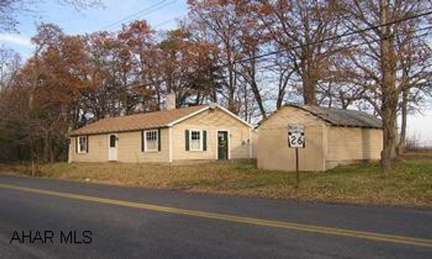 One story frame/vinyl dwelling, 1BR/1Ba on nearly half acre, partially wooded, corner lot. Good location, country setting
