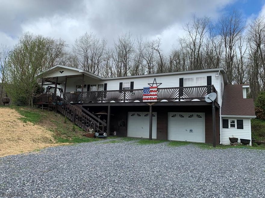 Extremely well maintained single family home on 2.03 acres in Southern Bedford County!  3 bedrooms, 2 full baths, large kitchen with island and beautiful oak cabinetry with built in china cabinets and desk area. Open living room with cathedral ceiling and a family room with beautiful built in oak cabinetry.  Large Master suite, walk-in closet, accompanied with a spacious master bath, separate shower, garden tub and double sink. Full basement with a 2 car garage and workshop/storage area.   Landscape with a large area for gardening. The title to the mobile home has been retired.