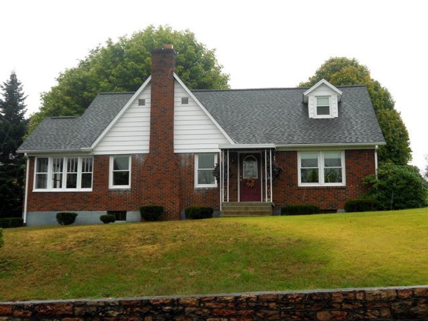 Well built brick home with a lovely view overlooking Everett. Situated in town close to many amenities, this home has new windows and roof w/ an inviting sun porch w/ wood pellet stove, an open cement patio and beautiful stone wall, and hardwood floors thru-out w/ many built-ins. Large living room has a fireplace. Two car integral garage on a corner lot. A really nice home priced to sell!