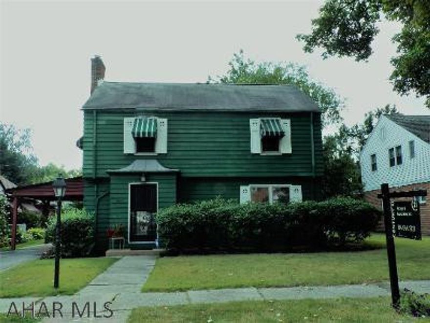 First time or forever home - this one is a perfect fit.  Charming two story with plaster walls, hardwood floors throughout and gas fireplace in the living room.  Central air conditioning for those hot days and awnings and shutters to provide some shade too.  Park-like back yard with mature trees and flowering plants.  Great curb appeal and great area!   Large carport with additional parking.  Finished room in basement.   List price reduced and it's move-in ready for your family!