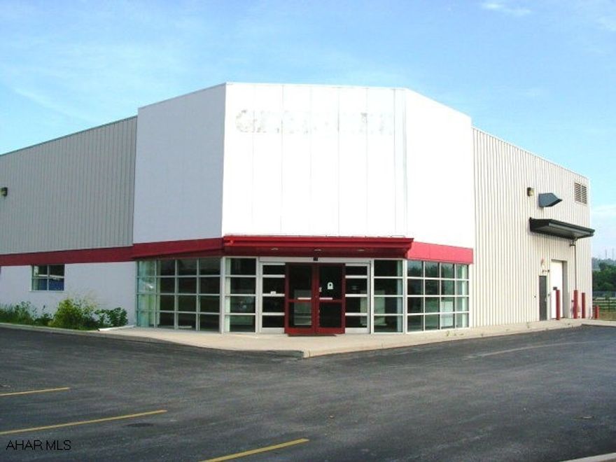 Commercial warehouse building on Rt. 22 between Hollidaysburg & Duncansville. 10,550 Sq. Ft. on 1.2 acres. Corner location with signal light. Showroom, offices, warehouse, docks, sprinkler system. Large parking lot.