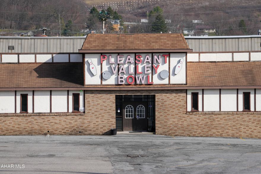 This is a prime commercial opportunity offering over 2 acres of high-visibility real estate just off I-99. Positioned in a high-traffic corridor ideal for continued business success or redevelopment, this location is worth a look. Located between State College and Bedford, the property offers an opportunity to expand into the area for new business. Currently featuring a substantial building exceeding 40,000 square feet, now home to the well-known 4Ds Lounge, and Pleasant Valley Recreation Center. Additional rental spaces within the property are currently occupied, 2 residential - 2 commercial, providing immediate income and investment stability. With over 100 parking spaces, the site easily accommodates large volumes of customers and events. There is an outdoor patio area for more entertainment! Combining strong visibility and multiple revenue streams, this location makes it a standout opportunity for investors or owner-operators looking to expand or reposition in a prime location. Call listing agent for more information.