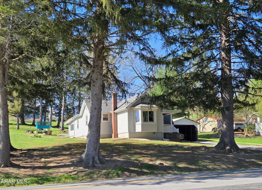 Hollidaysburg School. Updated 1 story vinyl sided 2 bedroom, home with 3 season room, great views, updated kitchen , bath and flooring, plus tarped sided carport on
.58 acres. J-683