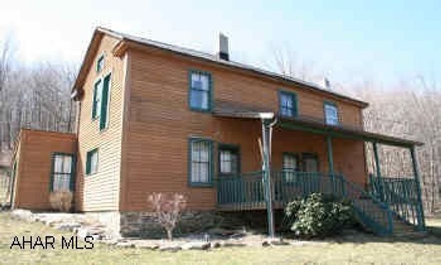 2-Story country house located on 43 acres w/views of the mountains. Has wood stove in Lr; eat-in kitchen: wood floors. Covered front porch; enclosed back sun porch. Has 1 outbuilding, open  field & wooded acreage w/ hunting. Also has wood/coal furnace.